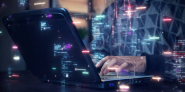 A software development designer or programmer is typing on a computer to create an application using an abstract code language in simulation. Digital cyber security technology concept.